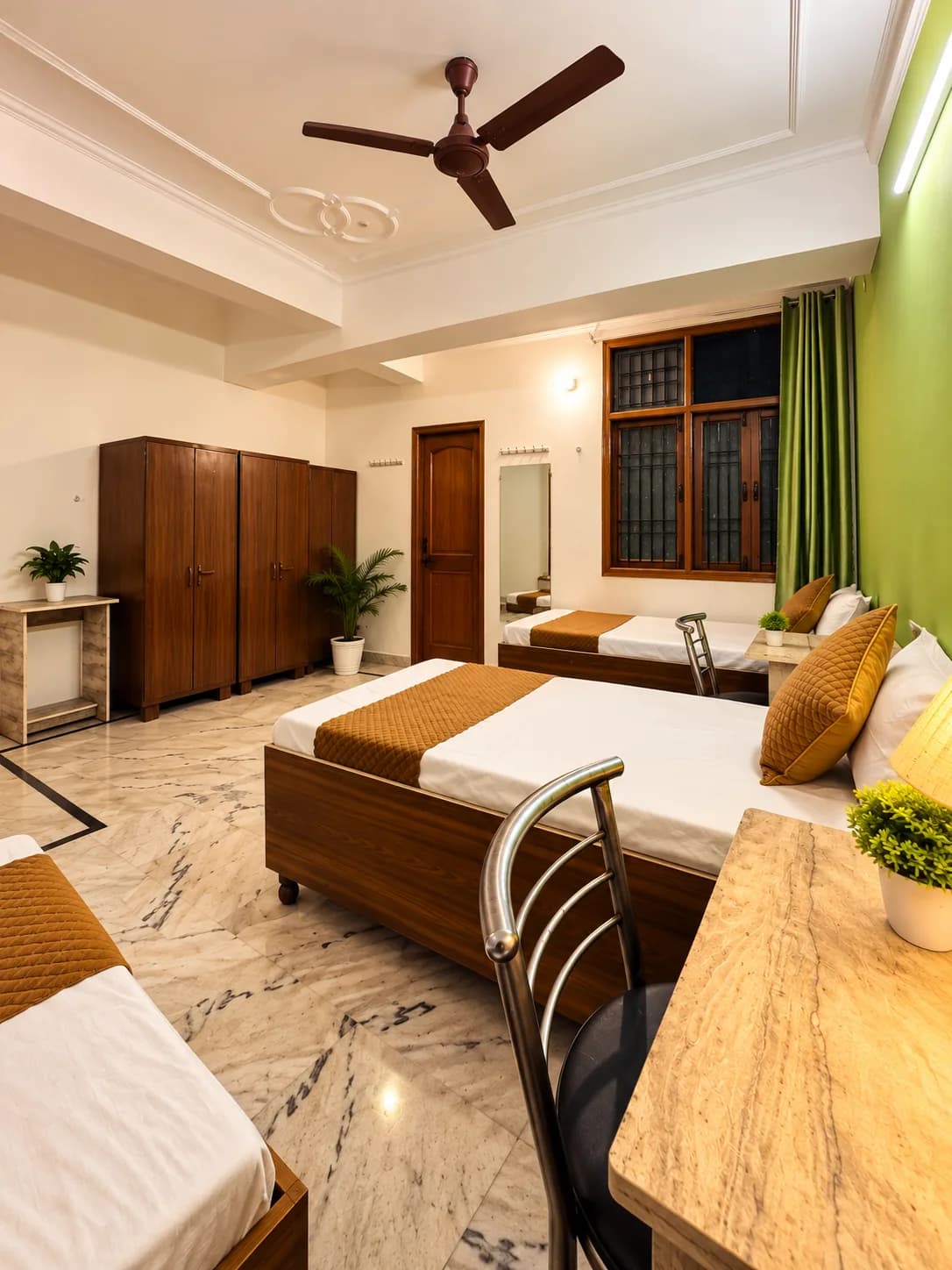 Furnished room with study desk, beds and wardrobes at Serenity PG in Sector 126 Noida